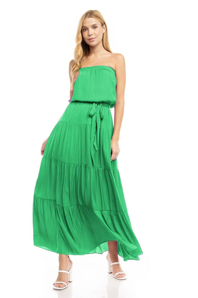 Woman wearing a green strapless dress on a white background
