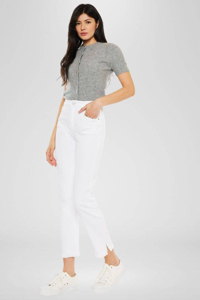 Woman wearing a gray short-sleeve top and white pants on a white background