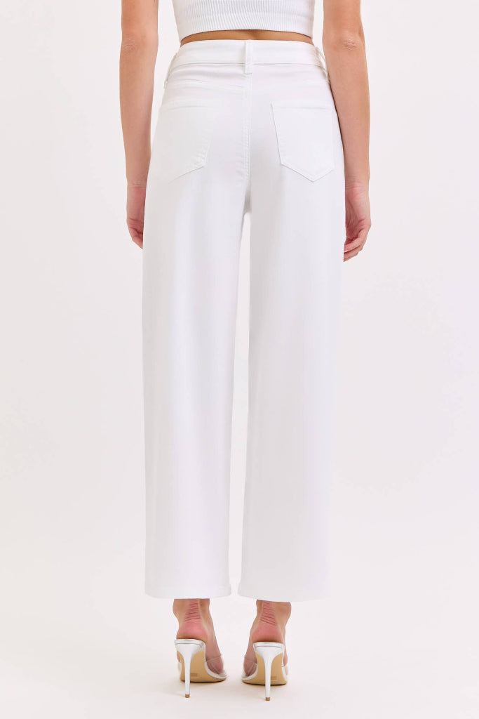White pants worn by a person on a white background