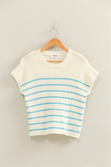 White and blue striped sweater on a hanger against a light gray background