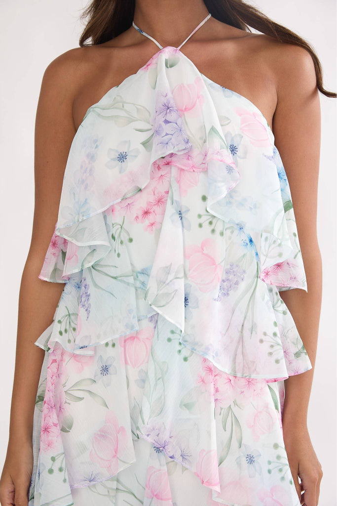 Floral dress with ruffled layers on a white background