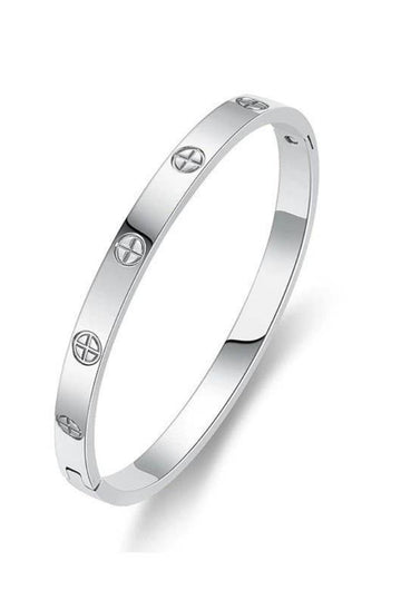 A polished silver-toned bangle bracelet with evenly spaced screw-head motifs, shown on a clean white background.