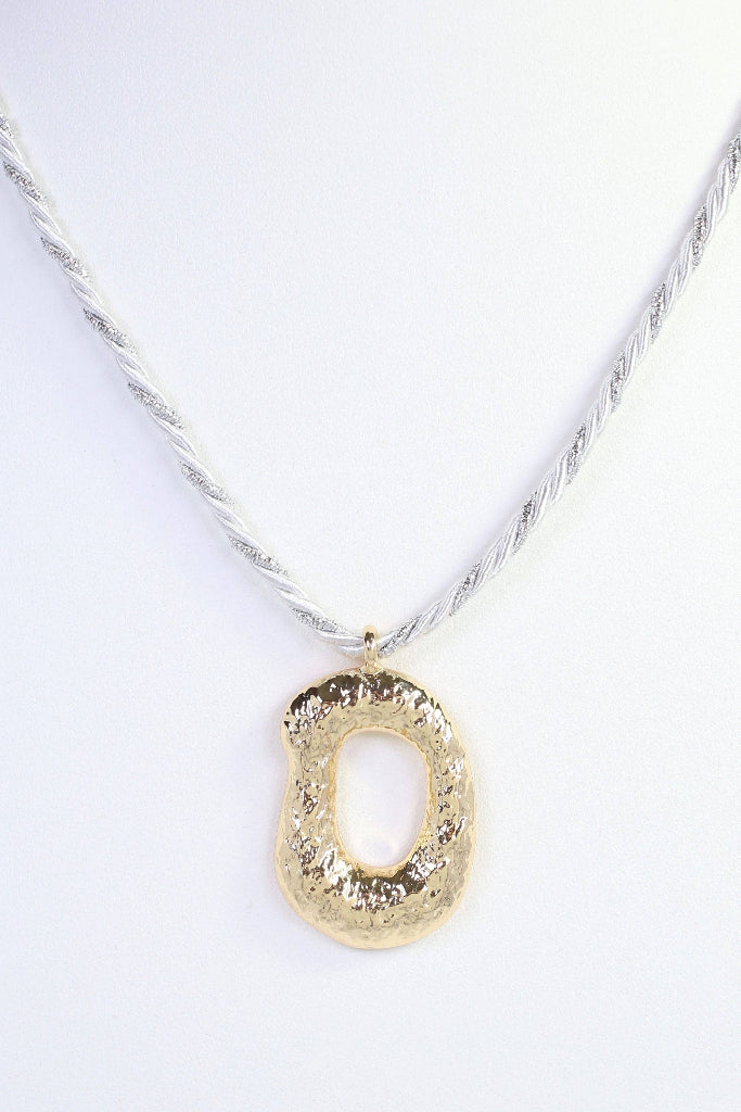 A textured gold pendant necklace on a twisted silver chain, displayed against a clean white background.