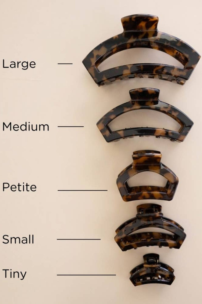 Five tortoiseshell hair claw clips in different sizes labeled Large, Medium, Petite, Small, and Tiny on a light beige background.