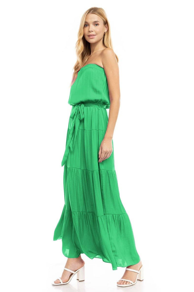 Woman wearing a green strapless dress on a white background