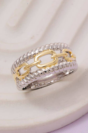 Two-tone gold and silver ring on a white background