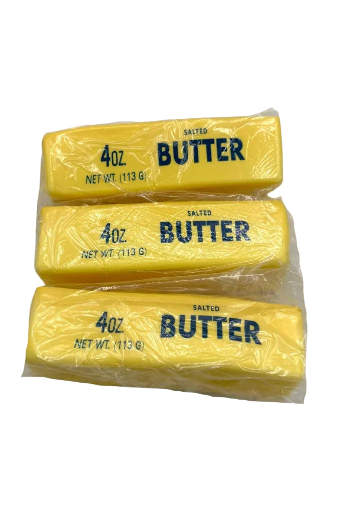 Three packages of 4oz salted butter on a white background