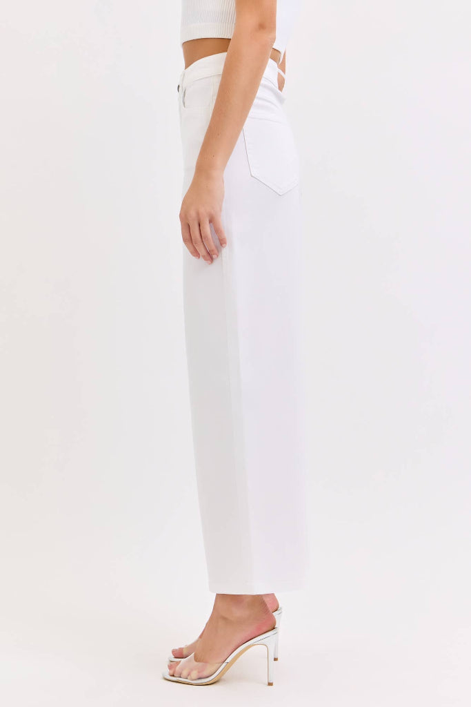White pants worn by a person on a white background