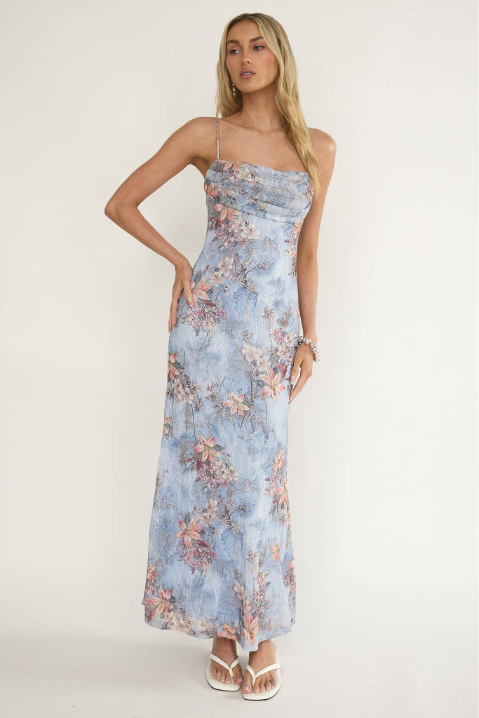 Woman wearing a floral dress against a white background