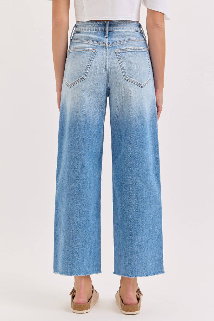 Light blue wide-leg jeans worn by a person on a white background