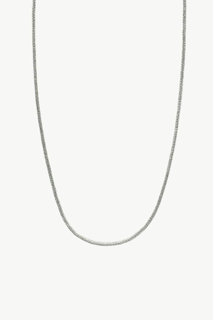 A silver-toned chain necklace shown against a plain light gray background.