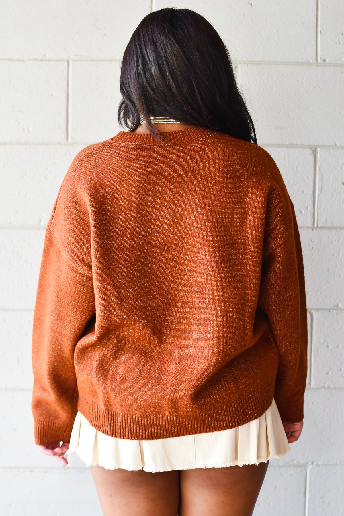 Back view of cognac knit crew neck sweater