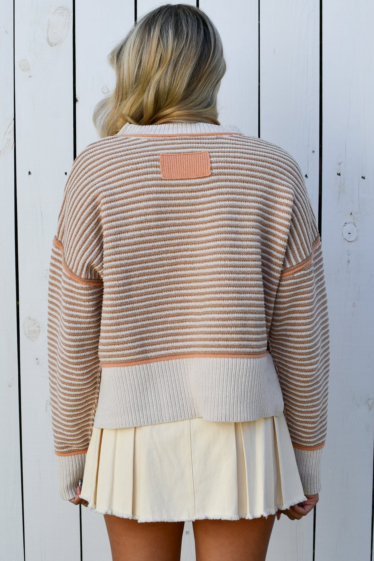 Back of beige striped knit sweater