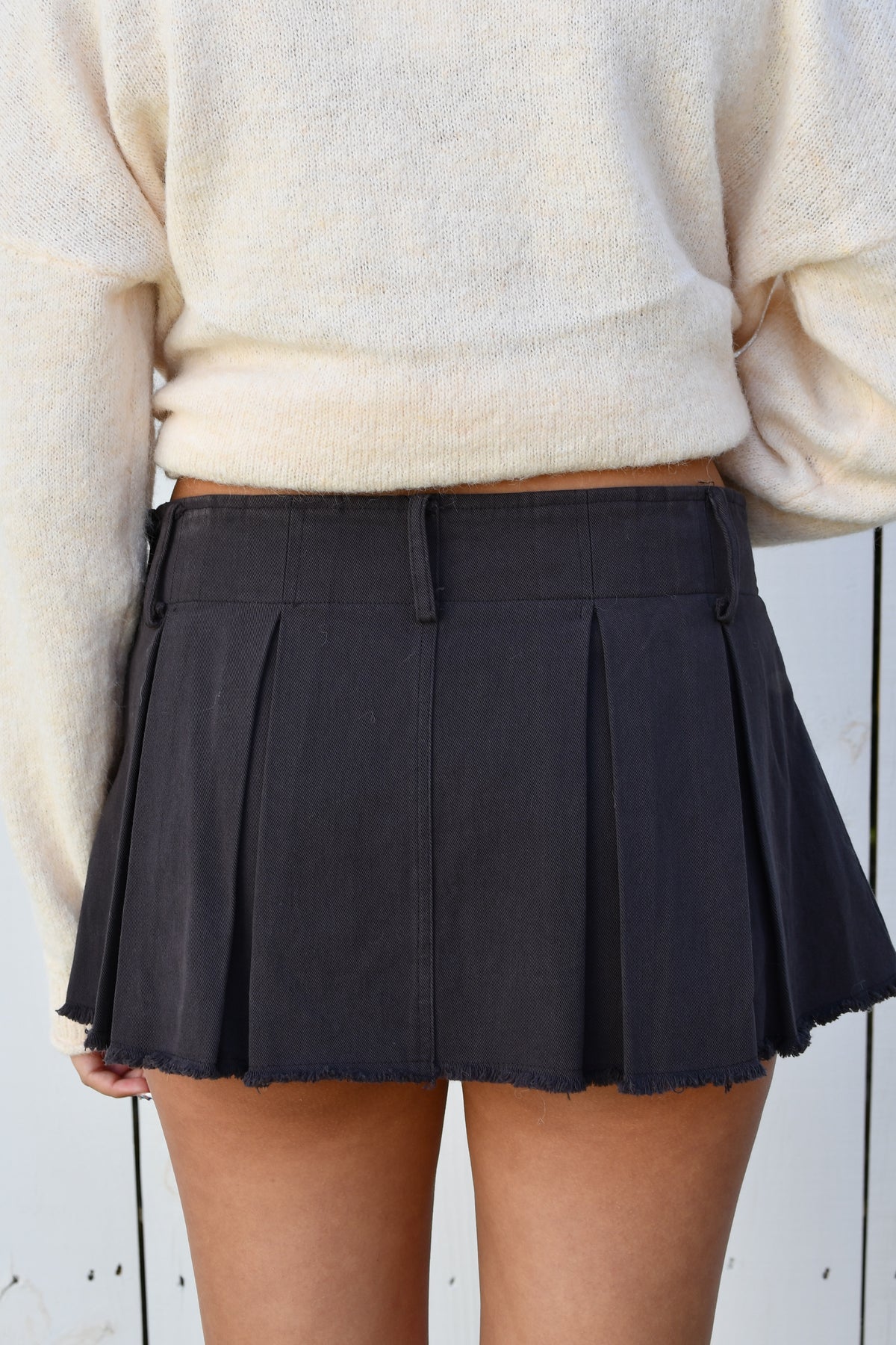 Back of charcoal pleated mini skort