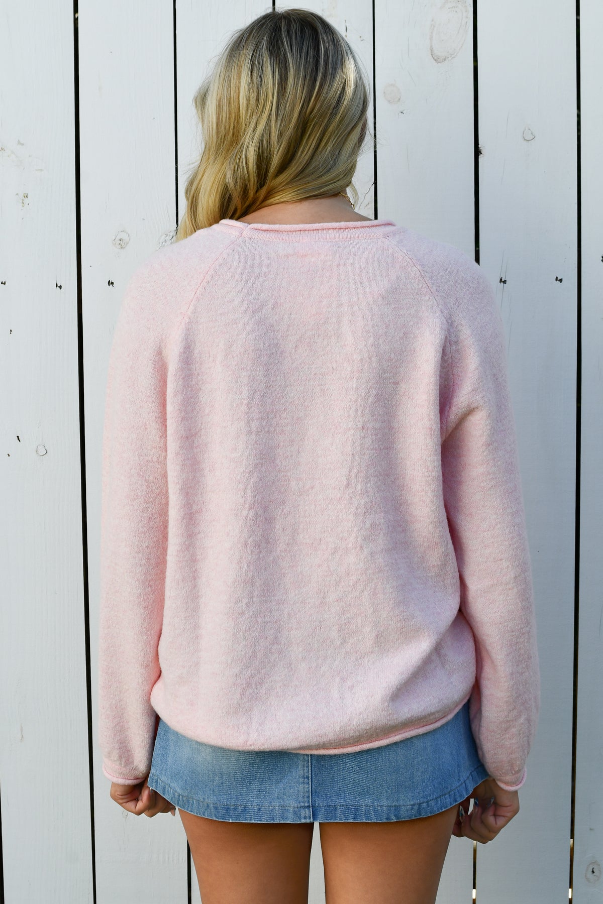 Back of pink fuzzy crewneck sweater