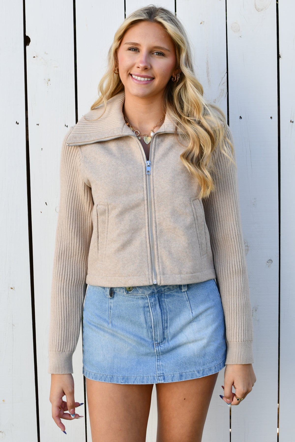 Model wearing taupe zip-front knit jacket with wide collar