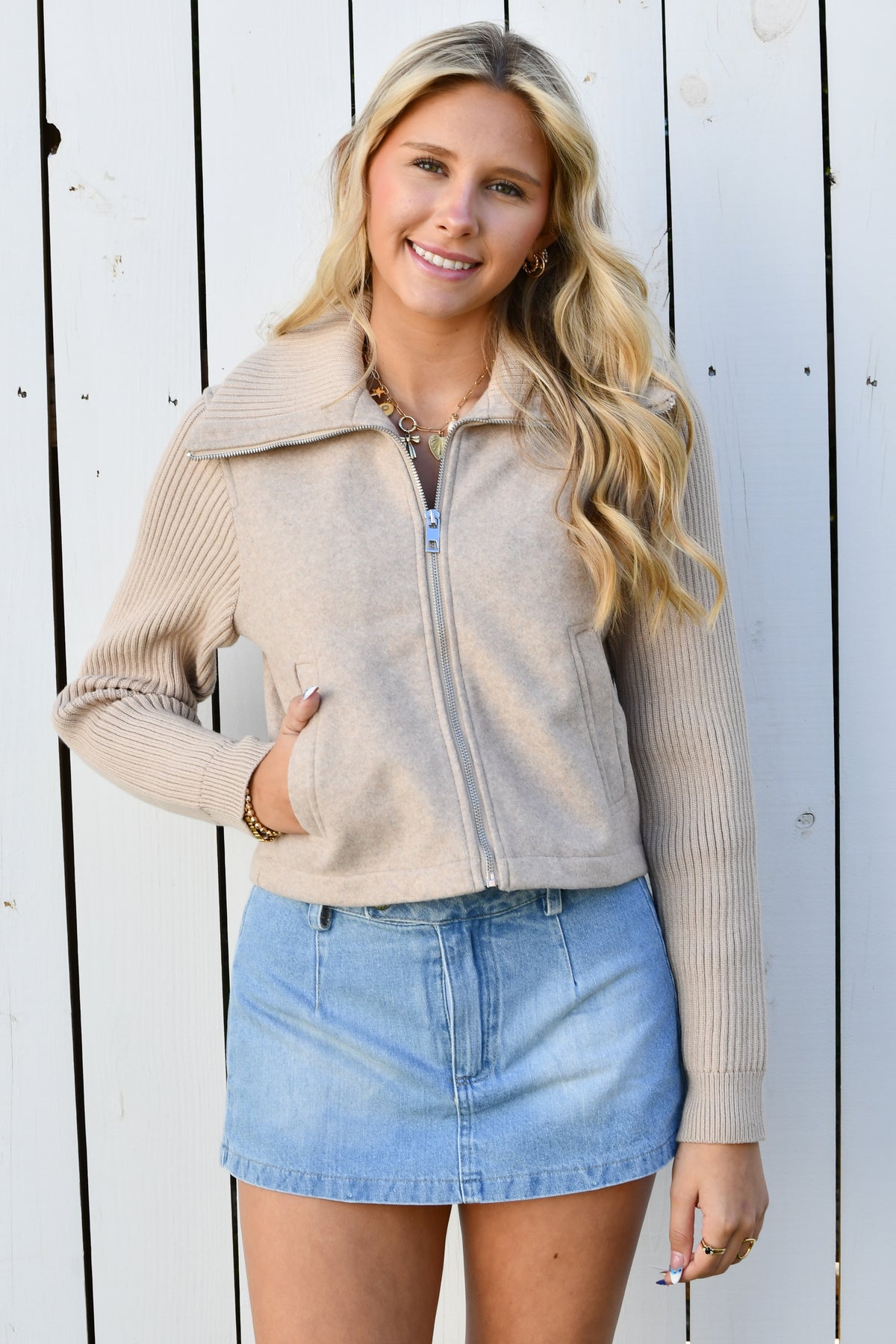 Taupe zip knit jacket shown with hand in pocket