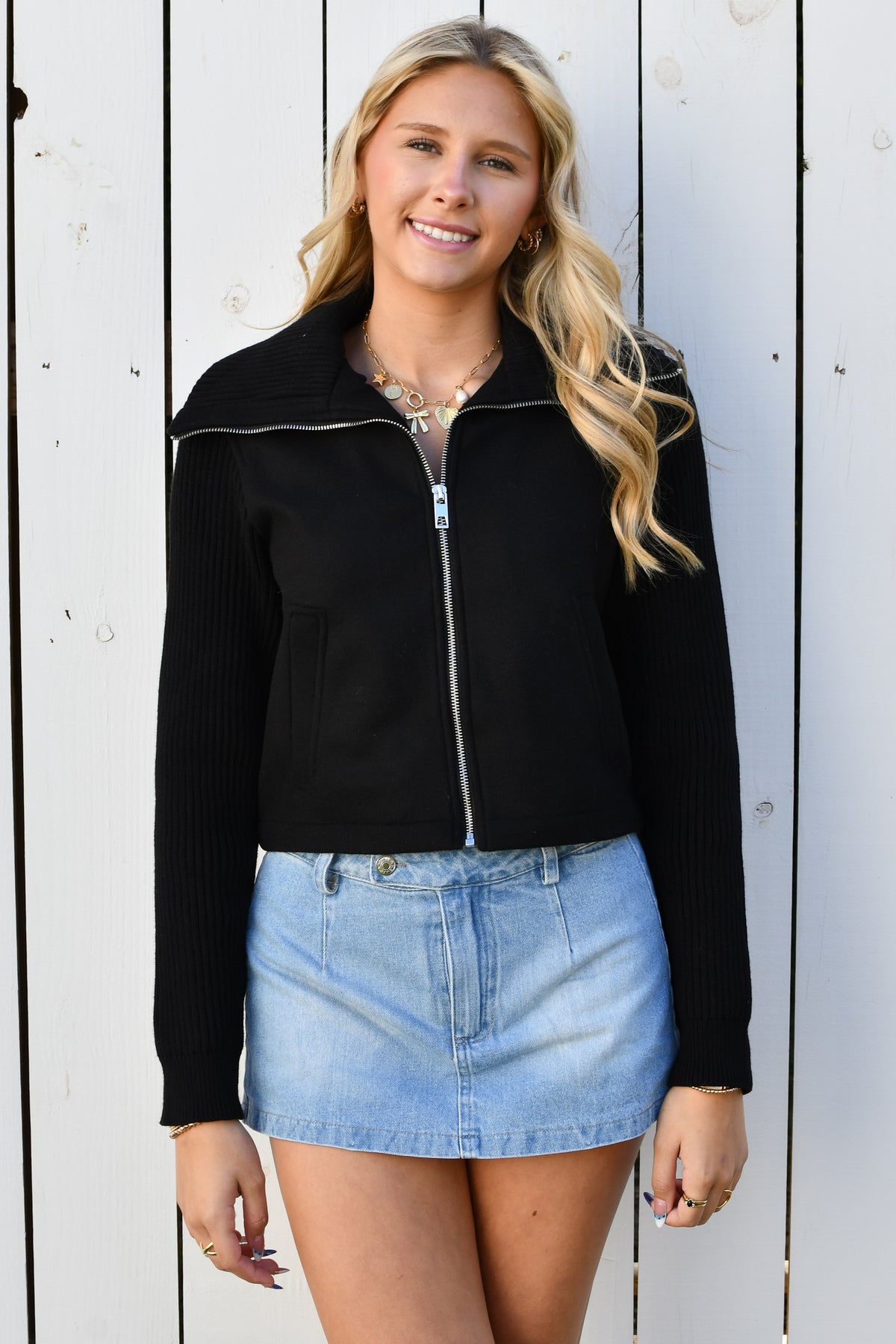 Model wearing black zip-front knit jacket with wide collar