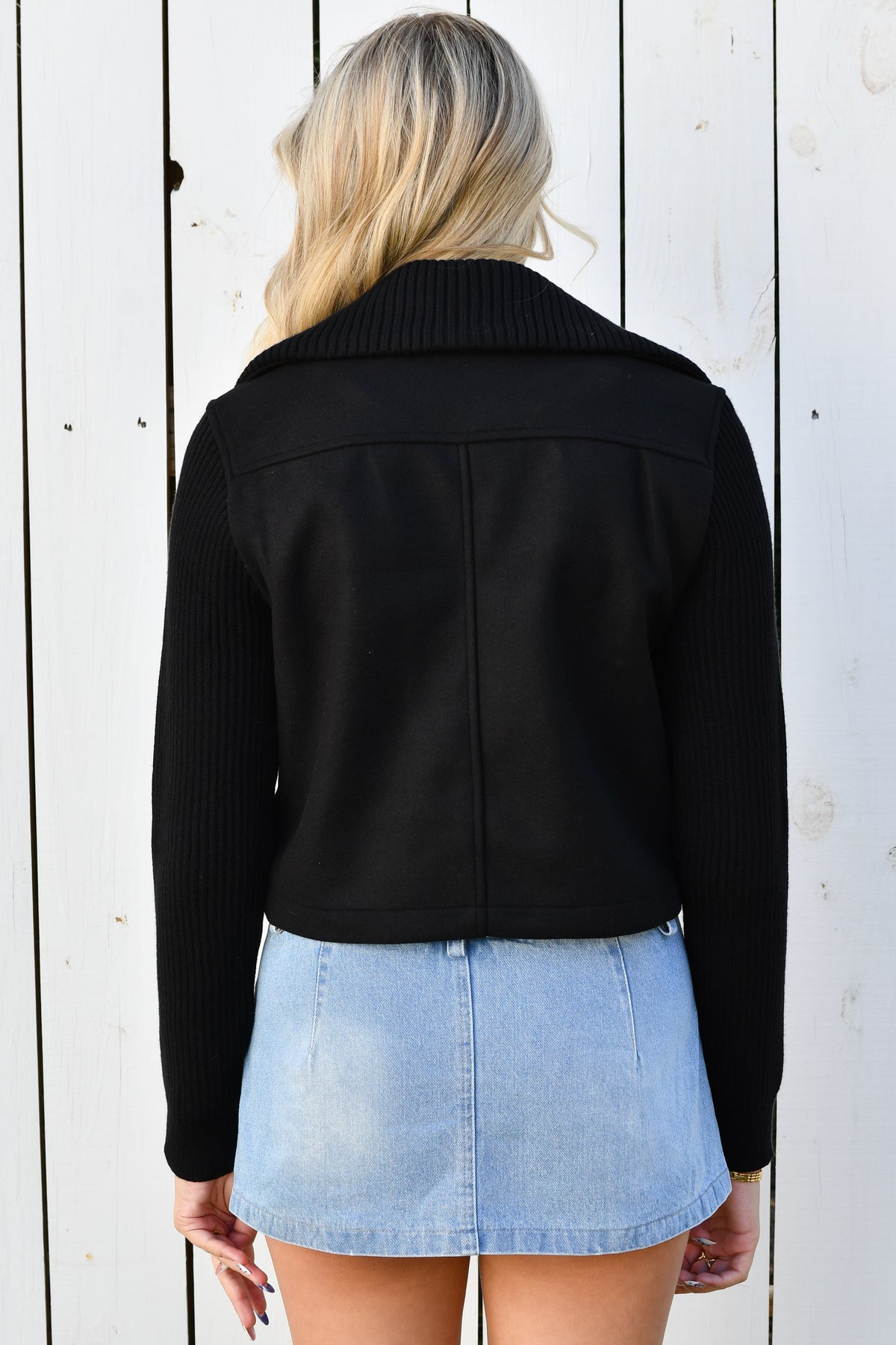 Back of black zip knit jacket