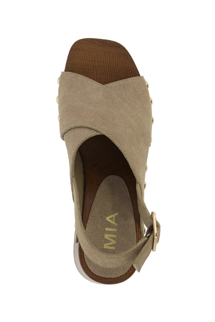 Beige sandal with brown heel and strap on a white background