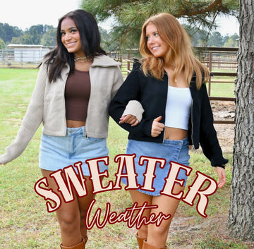 Sweater Weather drop. Two friends in zip up knit jackets with denim mini skirts.