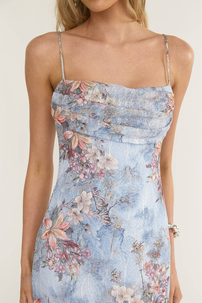 Woman wearing a floral dress with a white background