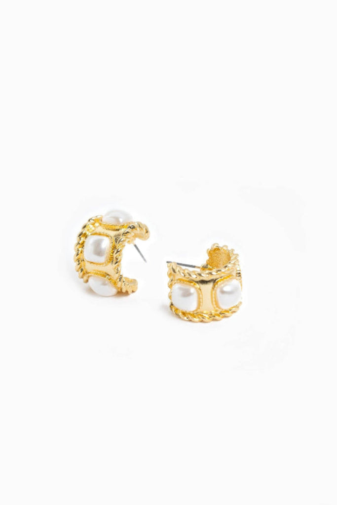 Pair of gold flower-shaped earrings on a white background