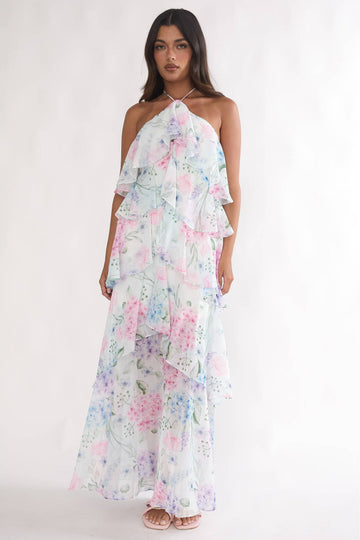 Woman wearing a floral one-shoulder dress on a white background