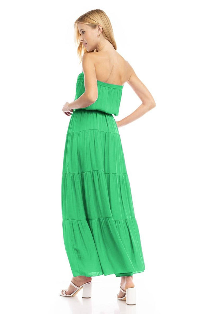 Woman wearing a green strapless dress on a white background