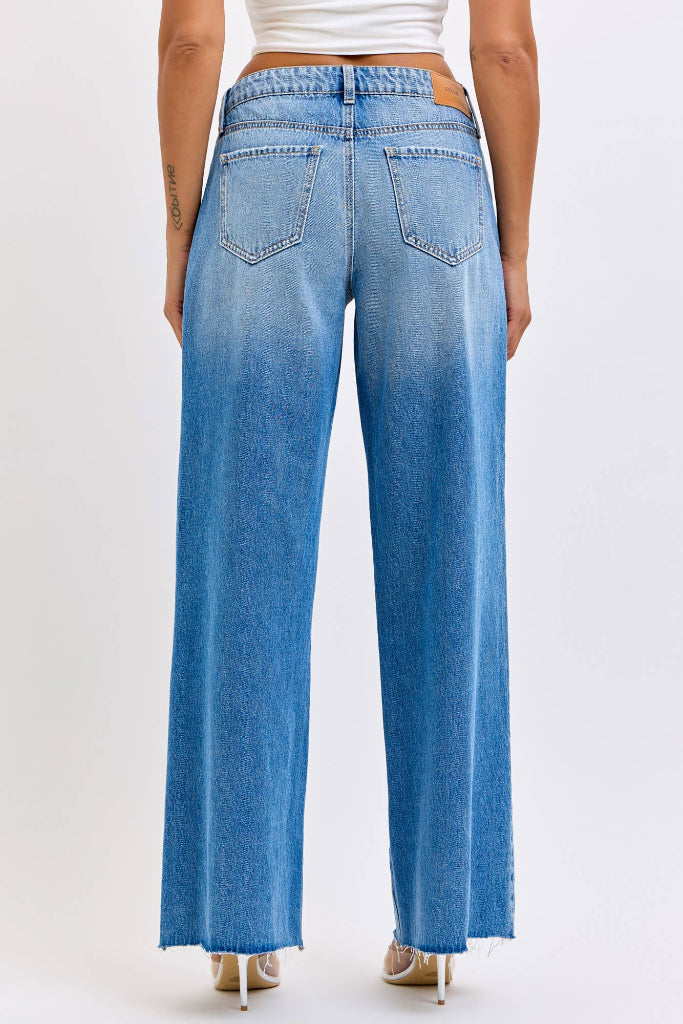 Blue jeans worn by a person on a white background