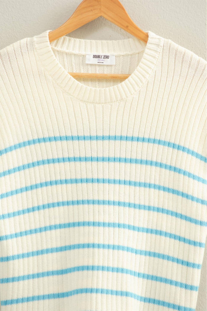 White ribbed sweater with blue stripes on a hanger against a gray background